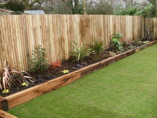 New Cedar Fencing with Flower Bed that has a 2x6 Cedar Border