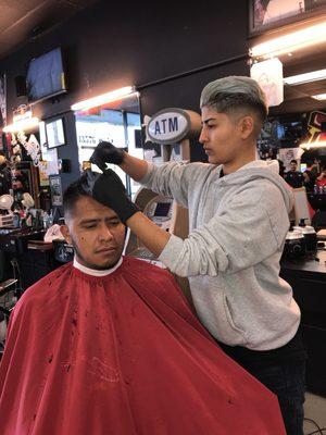 Our barber Eileen hooking up the client