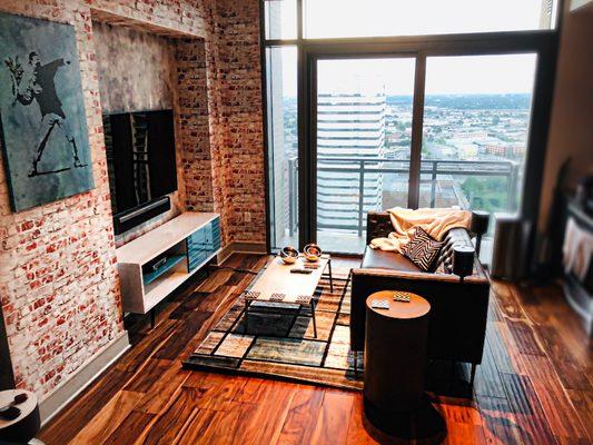 Look at those beautiful hardwood floors and floor to ceiling glass walls to see the view!