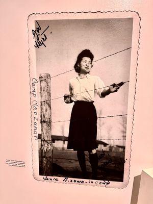 "Don't Fence Me In". Fusako 'Jonie' Aizawa stands by a concentration camp fence, Christmas 1944.