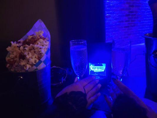 Our table, champagne and gourmet carmel bacon popcorn.