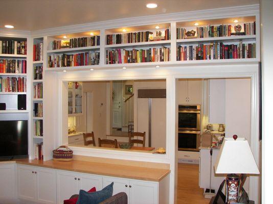 Lighted white shaker cabinets to showcase a whole library of books. Project in Portland, Oregon.