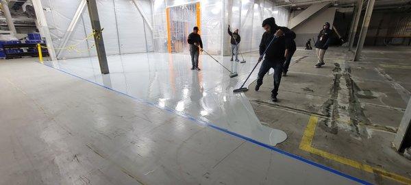 Applying first layer of Epoxy Floor Coating