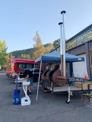 Smoking the meats right outside the storefront