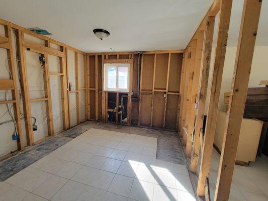 This area had the kitchen counter and mold on walls prior. Now it's ready for rebuild.