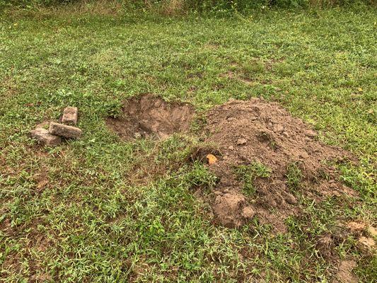 Yard dug up over septic tank. Left that way.