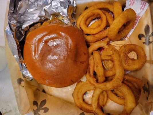 Jalepeno burger with cheddar cheese and onion rings.