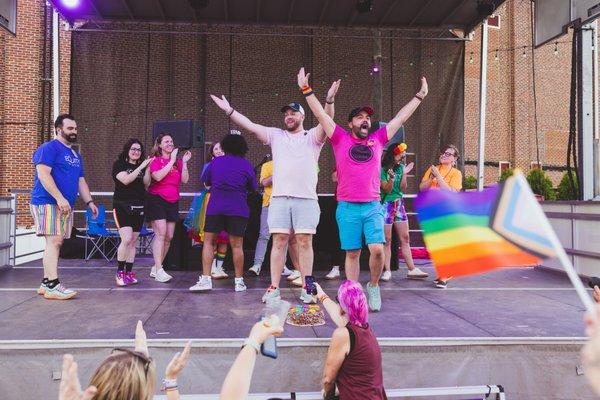 The JFKLiving Team sponsors Pride & Progress Night 2022 in Haddon Township. Photo of team leads Jeremiah & Pip on stage.