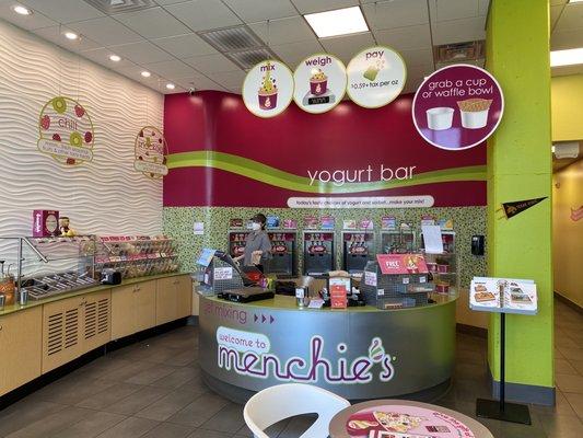 The yogurt bar! Walk around self-serve station with checkout kiosk in the middle.