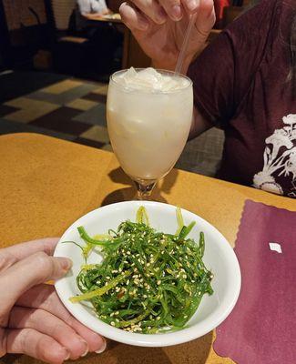 Hayley's enjoying her lovely creamy coconut beverage, and I'm diving into my seaweed salad. ^_^