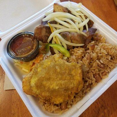 Fried Pork, rice and peas, pickled cabbage, plantain, onions