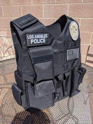 Vest carrier with a med pack and handcuffs on the side velcro straps