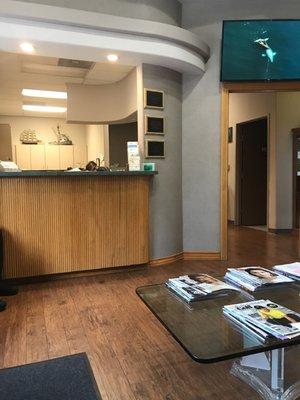 Small clean waiting room with a variety of magazines and National Geographic type video playing on television.