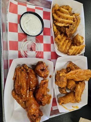 Waffle fries with blue cheese dressing, Hot Garlic wings next to fries, then Spicy Samurai wings.