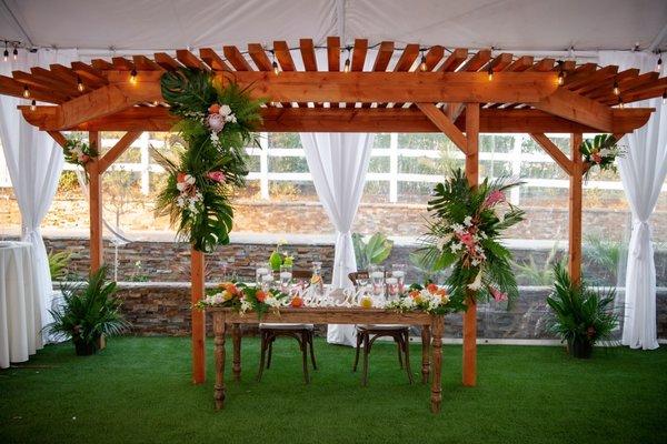 Arch for ceremony and sweethearts table.