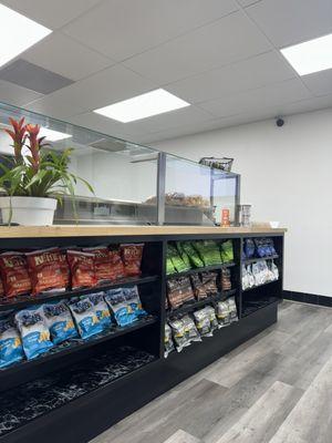 The front counter area with a few different flavors and brands of chips.