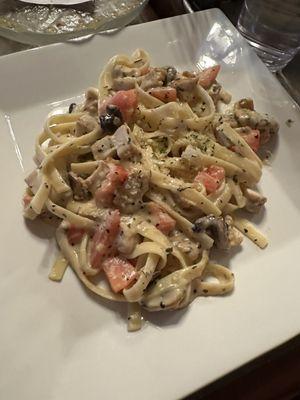 The fettuccine Alfredo is mixed with chicken and oh so delicious