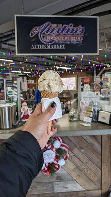 single scoop salted caramel pretzel in a sugar cone