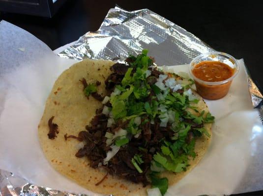 Barbacoa on corn tortilla w cilantro, onions