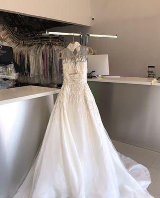 Seamstress was working on this wedding dress before the cleaning and preserving.