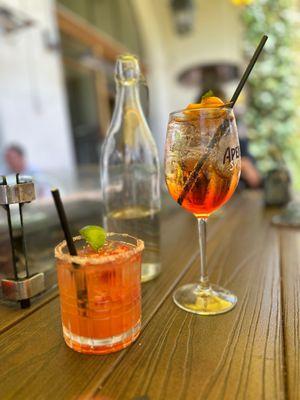 Strawberry margarita and aperol spritz