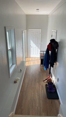 Inside view of vestibule/mudroom space and coat closet