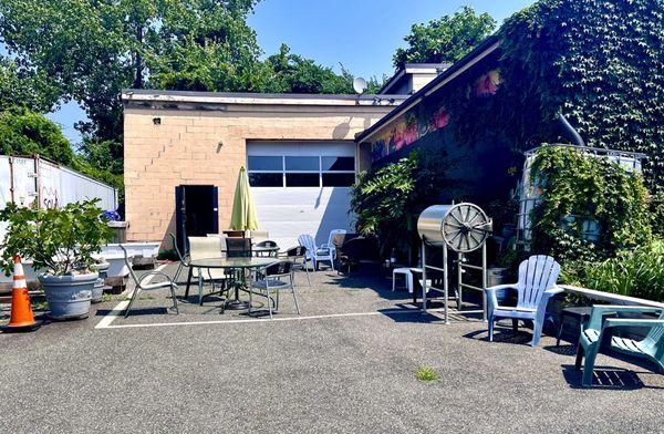 Some outdoor seating and equipment Behind the roastery