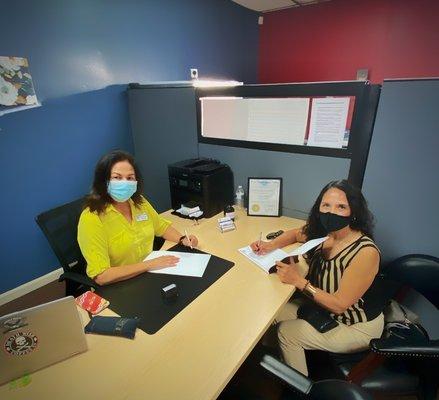 My mom and Mayra signing papers