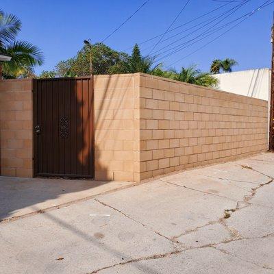 6 inch tan block with new wrought iron gate