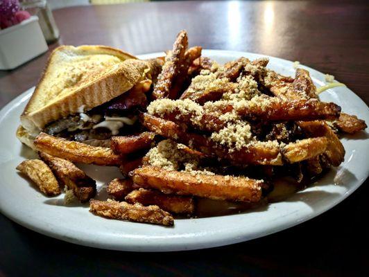 A mozzarella, ribye, bacon grilled cheese with sweet potato fries.