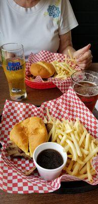 Pulled pork sandwich on top,  brisket sandwich below (with Bud light and Mack n Jack on tap), with fries and fry sauce.