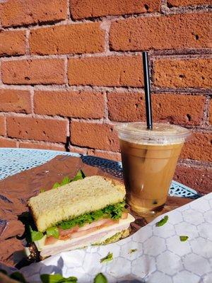 Montague sandwich on Gluten free bread, with a nitro cold brew with almond milk. Sitting on their outdoor patio table