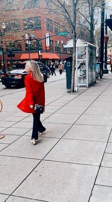 Red jacket, leather purse, nude classic leather shoes.