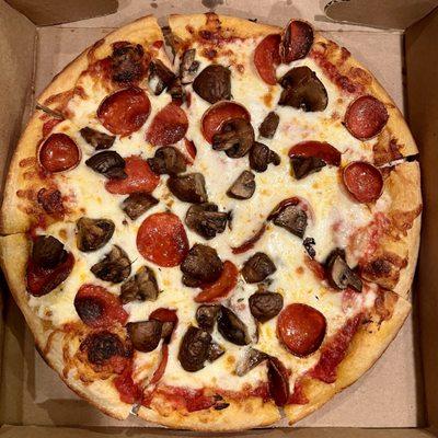 A small, 10" pizza with cup and char pepperoni and crimini mushrooms.