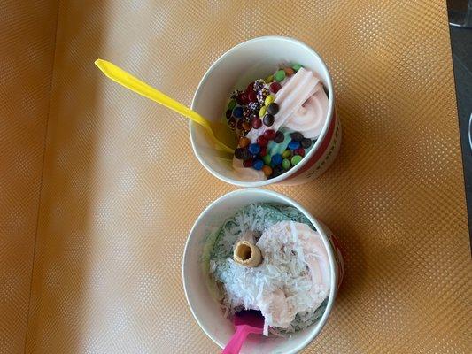 Two strawberry tart and mermaid flavored cups with toppings