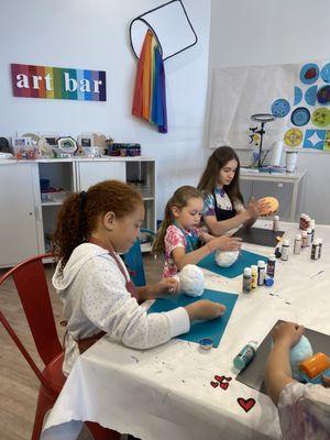 Art campers making little mushroom houses.