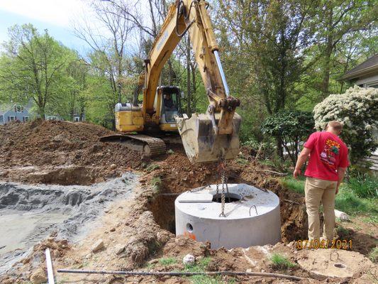 Setting a 1000 gallon septic tank in Randolph.