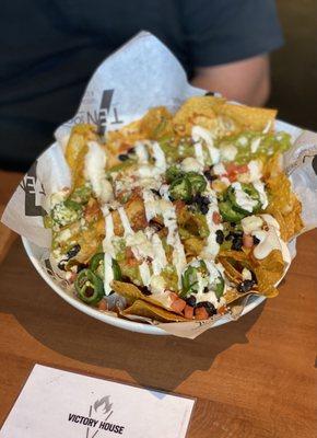 Nachos - my Step son says, "Really Good!" Chips smothered with tomatoes, black beans, jalepeno's, Mexican cheese, sour cream, guacamole.