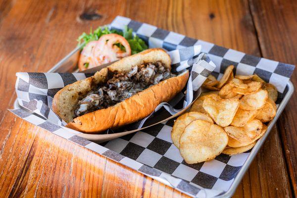 Sliced steak, griddled, topped w/ melted cheese, served on a toasted hoagie roll.