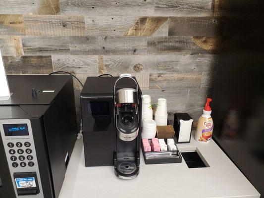 Keurig machine and coffee condiments.