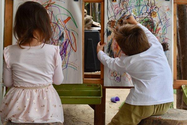 Our outdoor areas have easels where the children are able to paint and draw during the morning work cycle