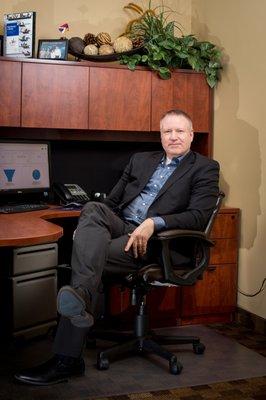 Dr. Larsen at his desk in his office at Lifestyle Hearing of Utah