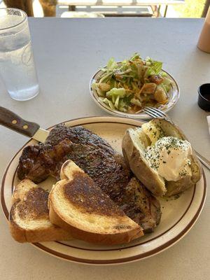 12oz medium rare ribeye steak and baked potato cooked to perfection