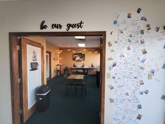 Visitor wall to sign and seating area