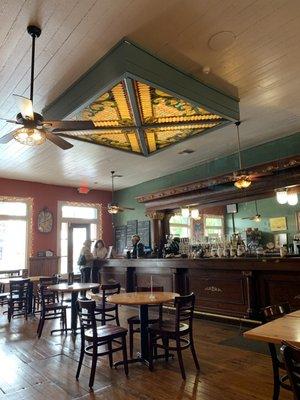 Beautiful wooden bar (serving gourmet teas and coffees) and stained glass ceiling fixture.