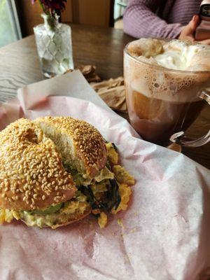 Green egg bagel sandwich with a mocha