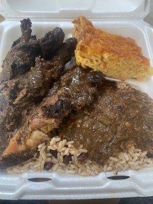 Jerk Chicken , Rice and Peas with Oxtail gravy Macaroni and Cheese