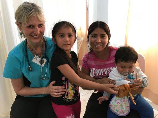 Dr. Mari Kay Evans-Smith with a family in Bolivia on a medical team trip