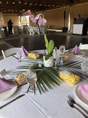 Tables set by venue (centerpieces by wedding party)