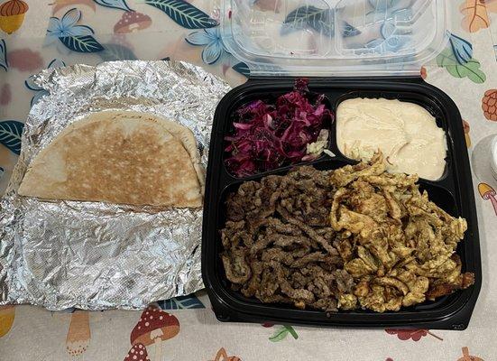 Shawarma combo plate, chicken and beef over rice, with salad, hummus, and bread